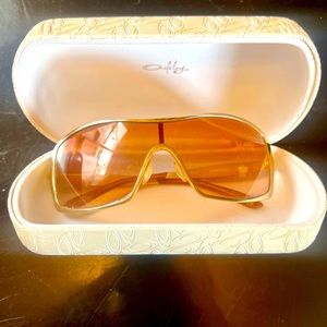 Oakley Sunglasses, gold frame with tan lenses in white hard case.